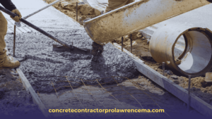 Concrete being poured on ground to make a side walk.